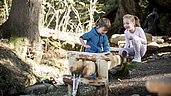 Im Urlaub Familienhotel Alpenhof Dolomit Family seid ihr direkt in der Natur. Kinder spielen im Wald.