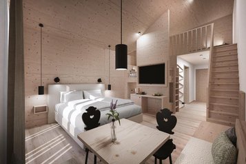 Sitzbereich in der 2 Raum Suite mit Sesseln, Kaffeemaschine und Wasserbar im Familienhotel Gorfion in Lichtenstein.