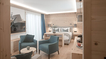 Sitzbereich in der 2 Raum Suite mit Sesseln, Kaffeemaschine und Wasserbar im Familienhotel Gorfion in Lichtenstein.
