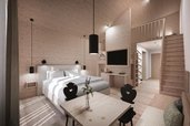 Sitzbereich in der 2 Raum Suite mit Sesseln, Kaffeemaschine und Wasserbar im Familienhotel Gorfion in Lichtenstein.