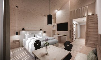 Sitzbereich in der 2 Raum Suite mit Sesseln, Kaffeemaschine und Wasserbar im Familienhotel Gorfion in Lichtenstein.