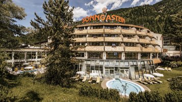 Die Außenansicht des Hotel Sonngastein im Salzburger Land zeigt das Hotel mit Pool im Sommer.