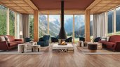 Gemütliche Lounge im Familienhotel Bella Vista mit Panoramafenstern, Kamin und Ausblick auf die umliegende Bergwelt.