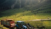 Traktor fährt durch die bergige Landschaft im Alpenhotel Kindl.