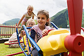 Kinder spielen auf dem Spielplatz vom Familienhotel Kaiserhof an der Tiroler Zugspitzarena.