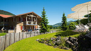 Große Außenanlage mit Blick auf die Berge im Spa- & Familien-Resort Krone im Allgäu.