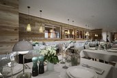 Der Speisesaal Valuna im Familienhotel Gorfion in Liechtenstein mit hell gedeckten Tischen im neuen Restaurant.