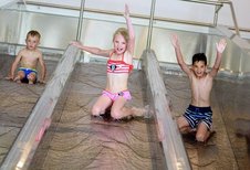 Drei Kinder rutschen die Triple Slide Rutsche des Almfamilyhotels Scherer hinunter.