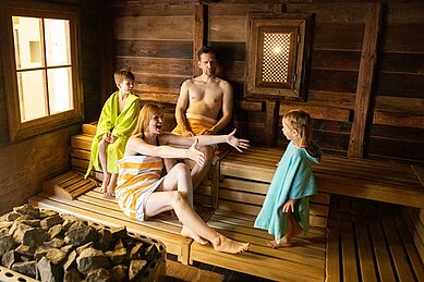 Eine Familie entspannt im in der Sauna des Familienwellness im Familienhotel Seeklause.