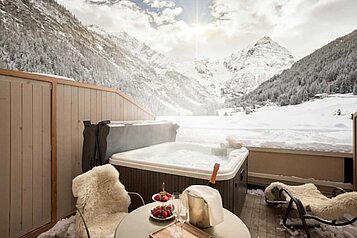 Whirlpool in einer Schneelandschaft im Familienhotel Bella Vista in Südtirol.