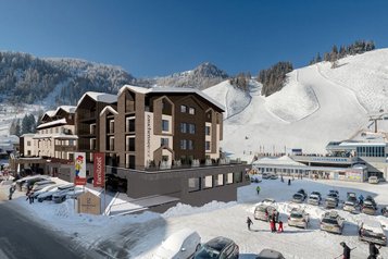 Visualisierung des Familienhotels Zauchenseehof im Winter mit direkter Lage an der Skipiste und Blick auf die Talstation der Zauchenseebahn.
