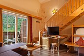 Wohnbereich mit einem Balkon in der Familiensuite im Familienhotel Alphotel Tyrol Wellness & Family Resort in Südtirol.