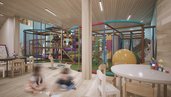 Ein heller Softplay-Innenbereich mit Kletterelementen und Spieltischen im Familienhotel Gorfion in Liechtenstein.