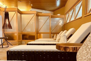 Gemütlicher Ruhebereich mit Liegen und warmem Holzinterieur im Wellness- & Familienhotel Egger.