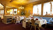Gemütliches Restaurant mit Tageslicht und Babyhochstühlen im Familienhotel Bavaria im Allgäu.