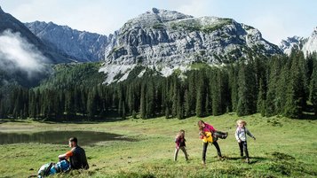 Eine Familie beim Wandern in den Tiroler Bergen rund um das Familienhotel Das Kaltschmid in Tirol.