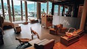 Indoor Spielbereich im Familienhotel Mia Alpina in Tirol mit Sitzlounge, Spielteppich, großen Fenstern und Bergblick.