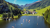 Blick über den Zauchensee auf das Familienhotel Zauchenseehof im Salzburger Land