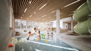 Kinder spielen und planschen im Indoor-Wasserbereich mit Rutsche im Familienhotel Gorfion.