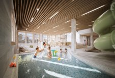 Kinder spielen und planschen im Indoor-Wasserbereich mit Rutsche im Familienhotel Gorfion.